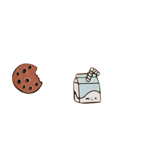 Cookie and milk carton pins on a textured white background