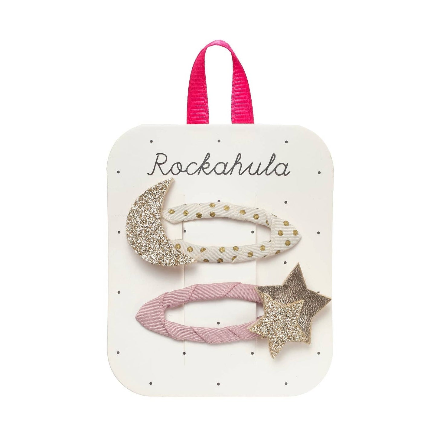 A set of three hair clips displayed on a white card with a pink ribbon loop. The clips include a glittery crescent moon, a white elastic band with gold polka dots, and a pink braided elastic band with a glittery star.