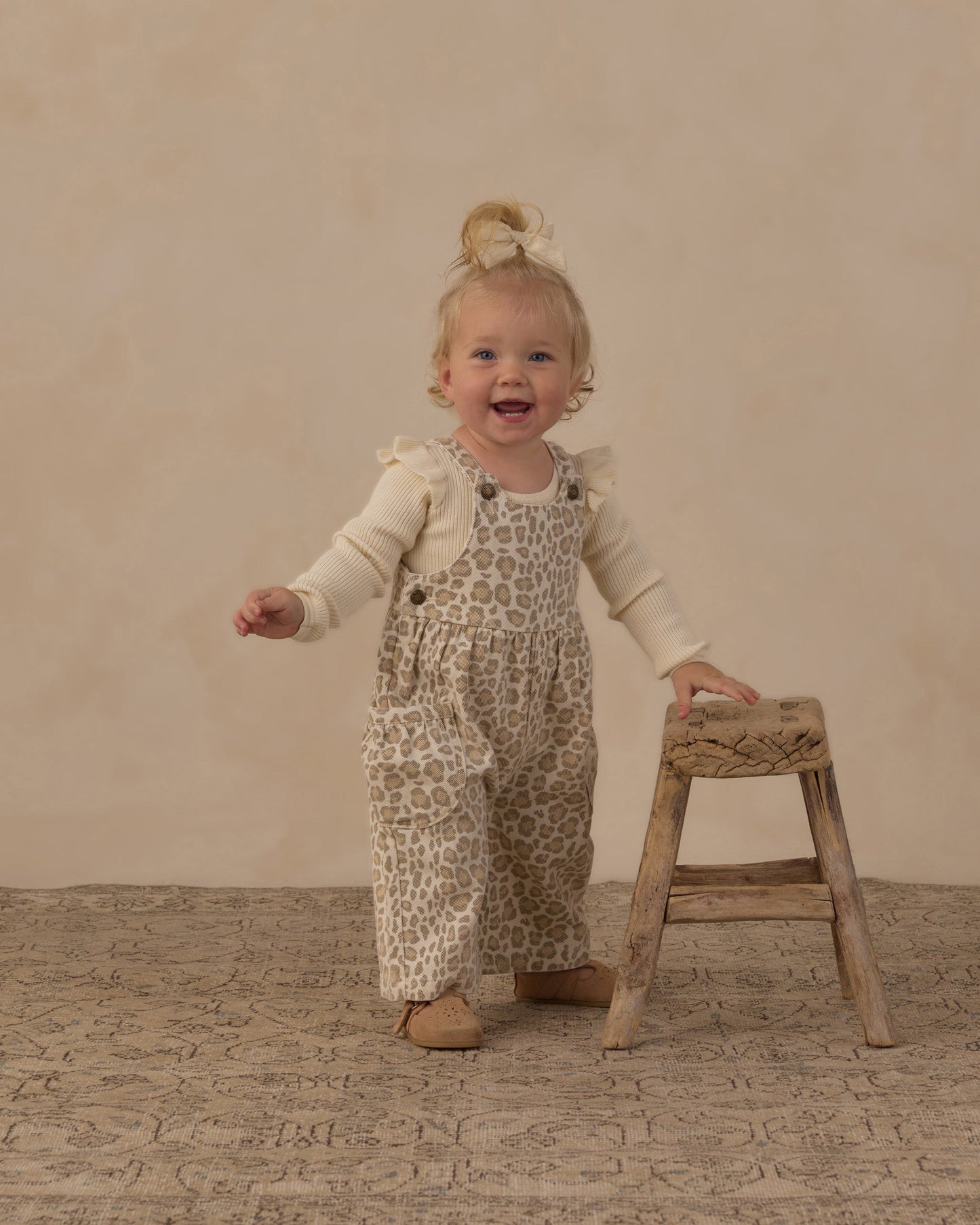 Baby wearing the natural ruffle shoulder onesie