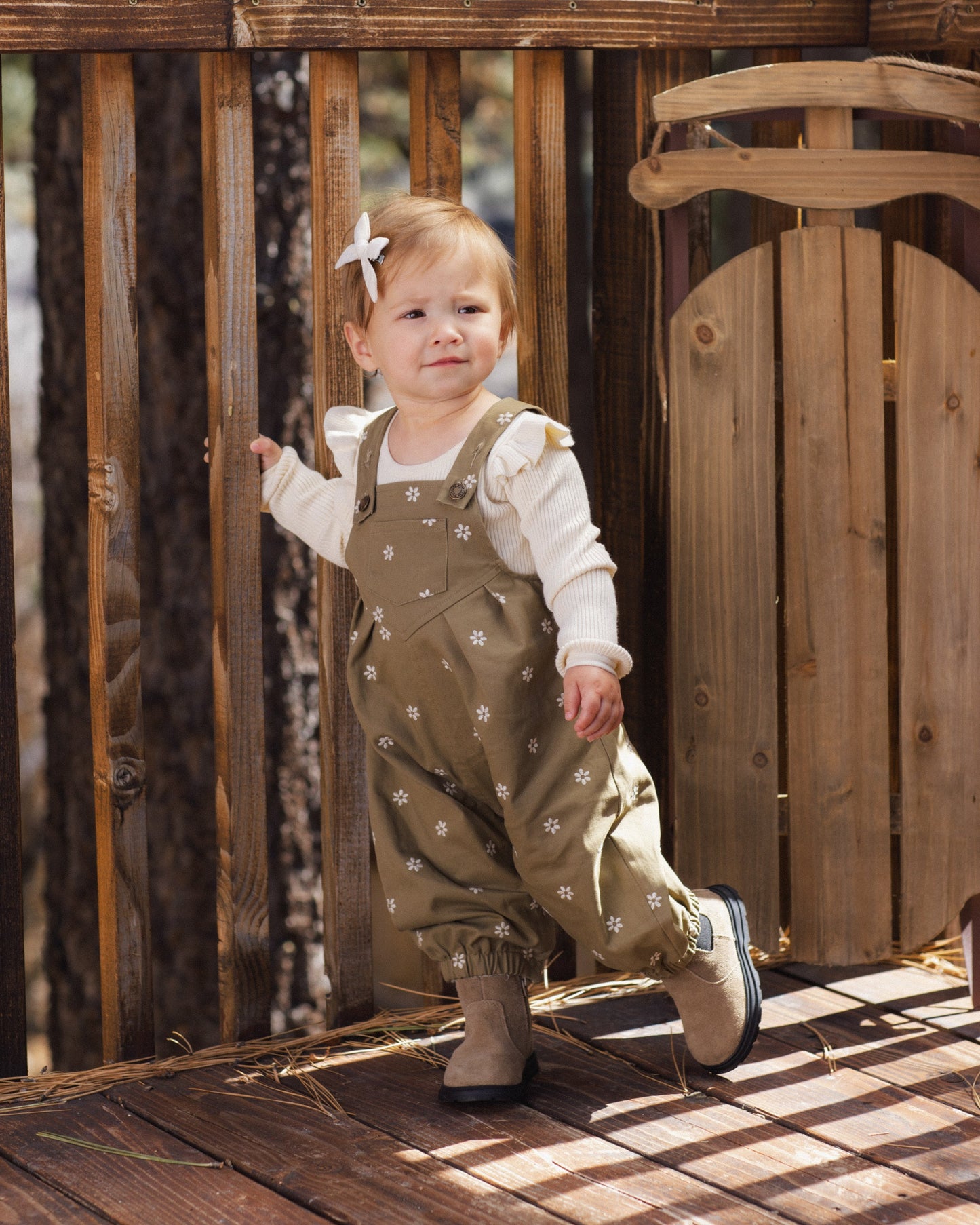 Baby in the natural ruffle shoulder onesie outdoors