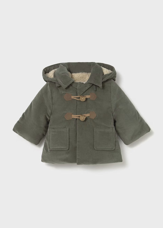 Green baby's coat with brown buttons on a light gray background