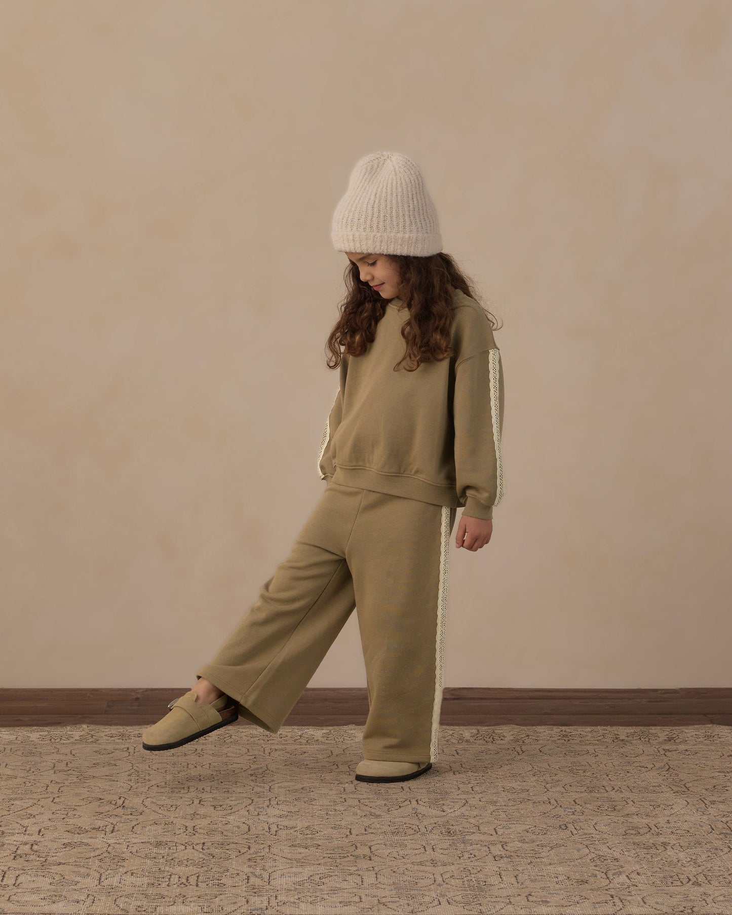 Close-up of lace trim detail on the olive sweatpant