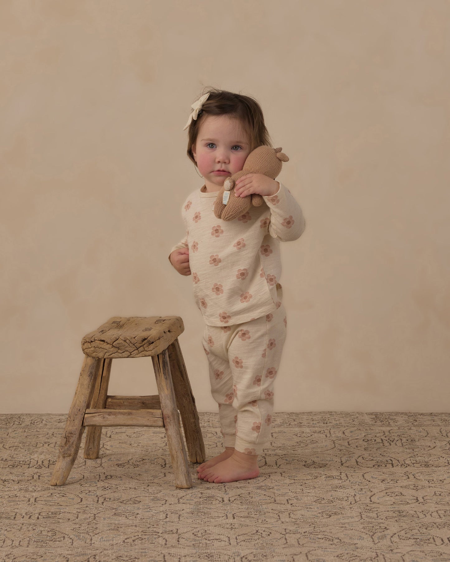 Baby wearing the pink daisies long sleeve tee and pant set by Rylee and Cru