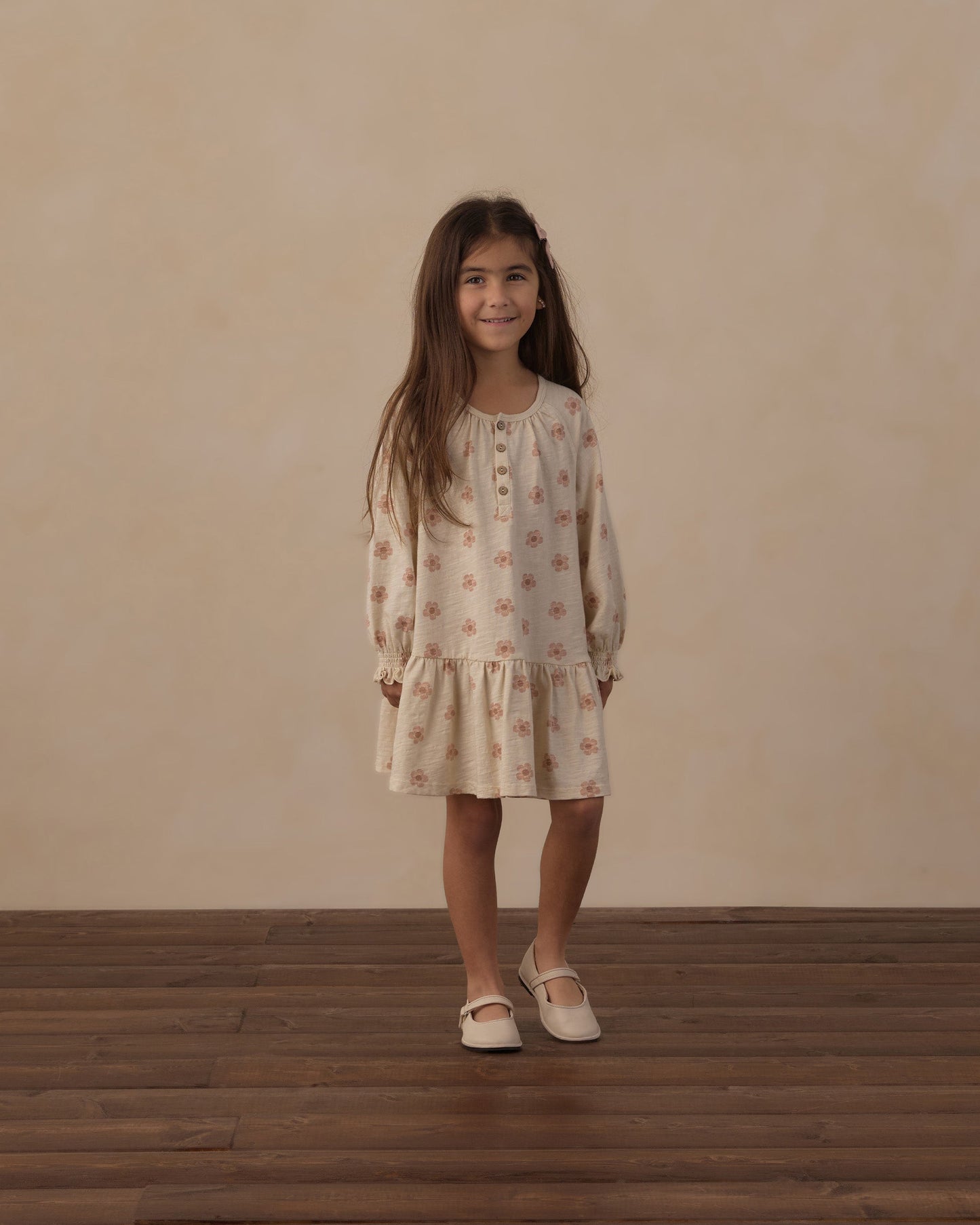 Child playing outdoors in the Pink Daisies Swing Dress