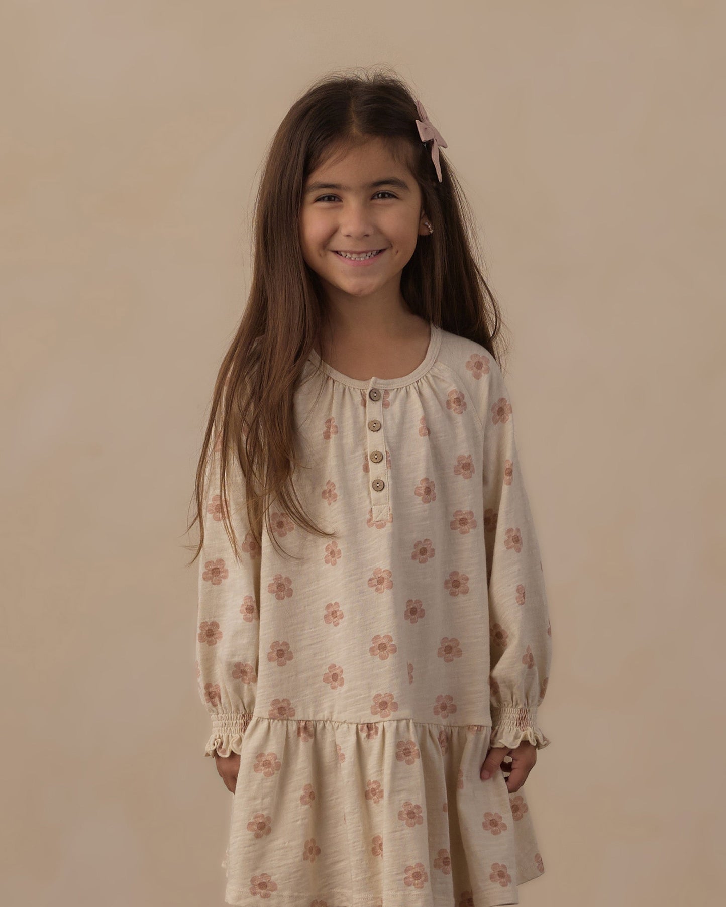 Girl standing in the Pink Daisies Swing Dress showing the gathered lower tier