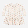 Girl wearing the Pink Daisies Swing Dress with long sleeves and button snaps