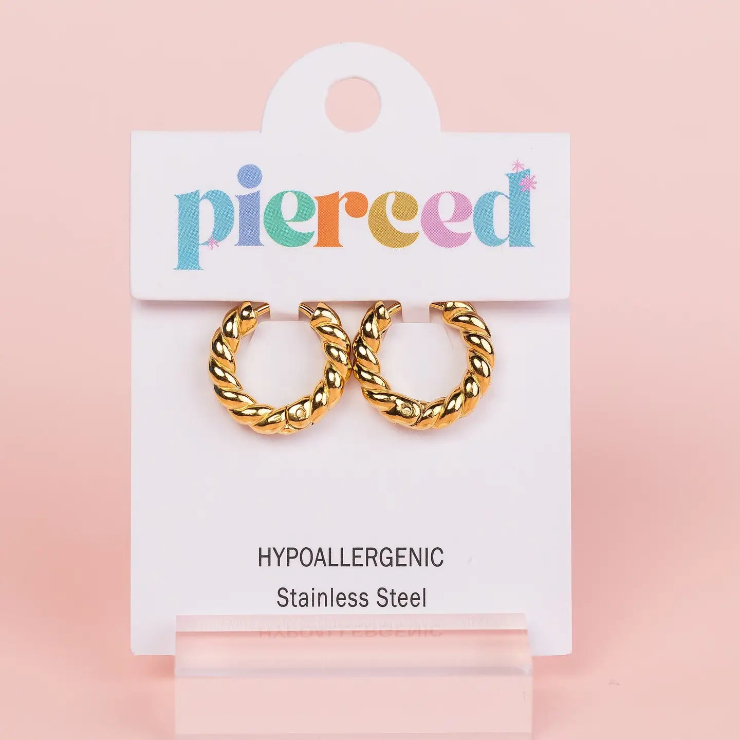 Gold hoop earrings on a 'pierceed' branded card 