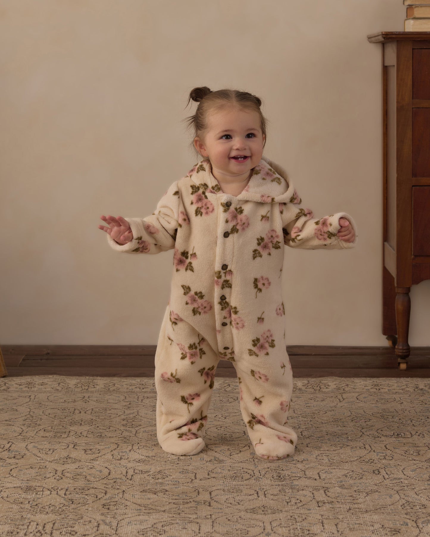 Baby wearing the hooded rose garden fleece jumpsuit