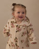 Baby in the rose garden fleece jumpsuit outdoors