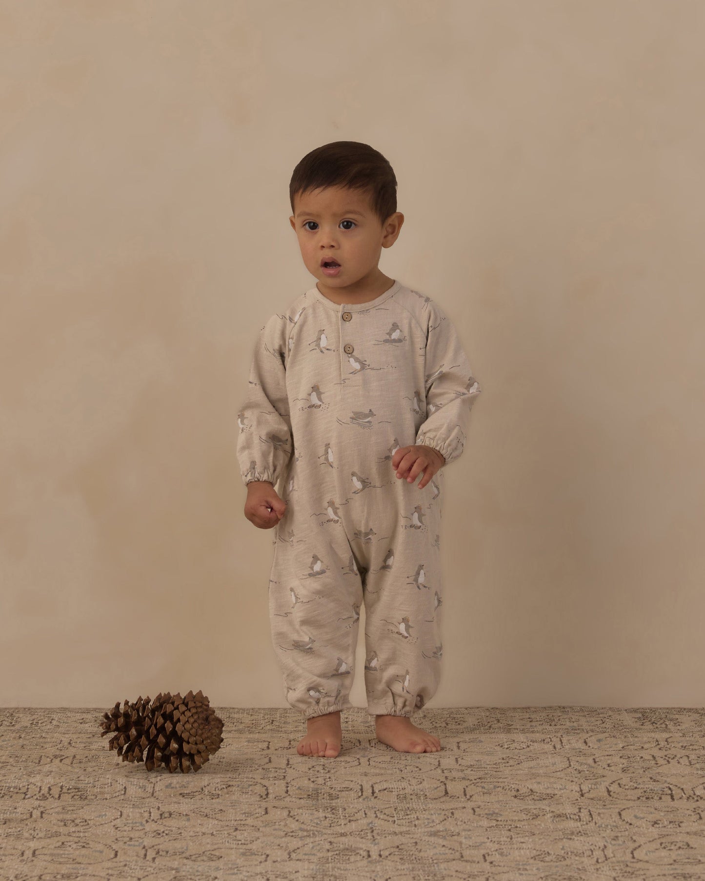 Baby wearing the skiing penguins henley romper