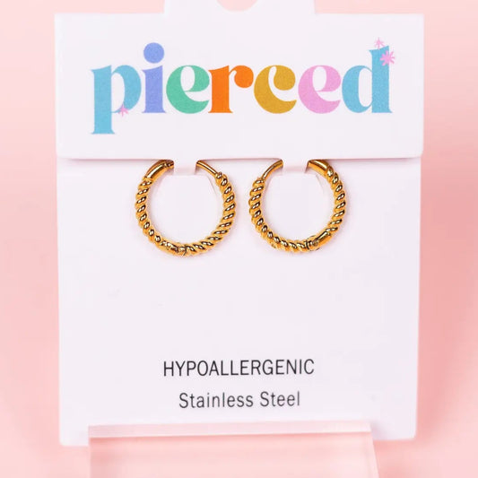 Gold hoop earrings on a 'pierceed' branded card with a pink background