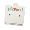 Pair of small round earrings on a 'pierced' branded card against a pink background