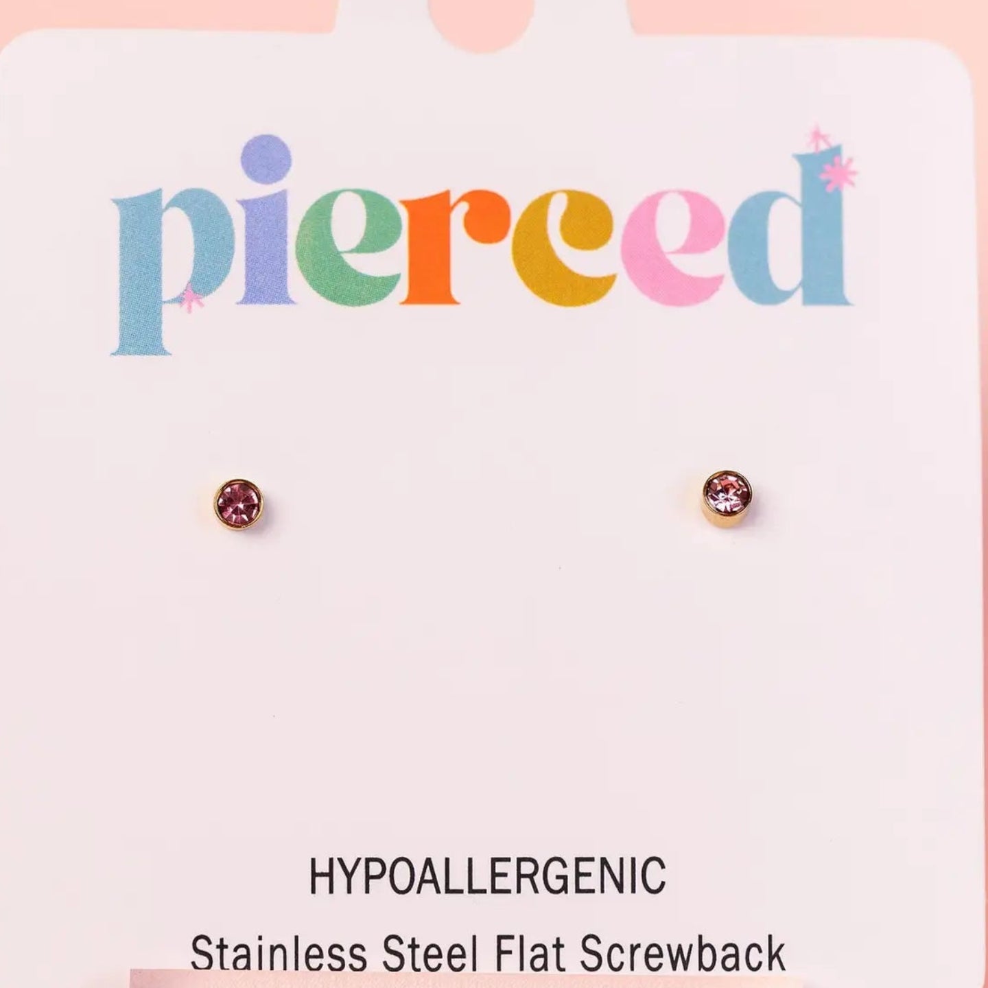 Pair of earrings on a 'pierceed' branded card with a pink background