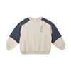 Beige sweatshirt with navy sleeves and a lightning bolt design on a white background