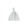 White baby hat with a knot on a white background