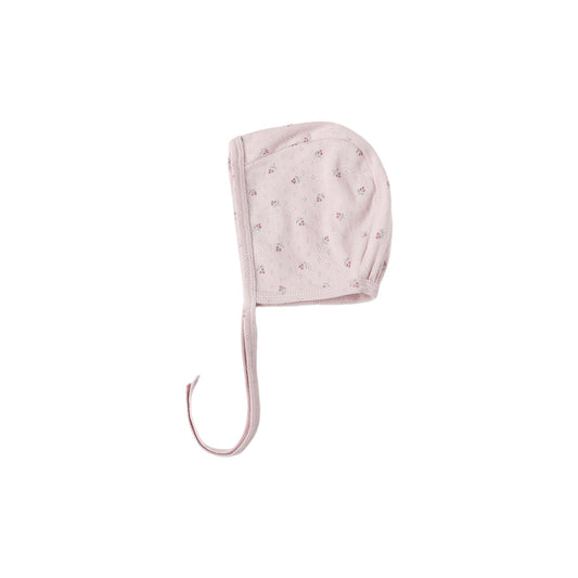 Pink baby bonnet with star pattern on a white background