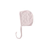 Pink baby bonnet with star pattern on a white background