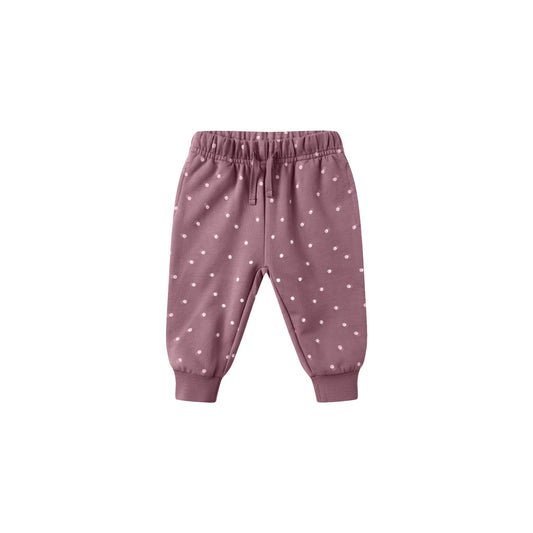 Pink baby pants with white polka dots on a white background
