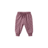 Pink baby pants with white polka dots on a white background