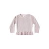Pink ribbed sweater with ruffled hem on a white background