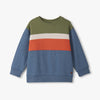 Color-blocked sweater with green, blue, and orange on a white background