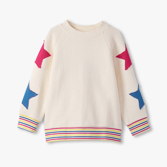 Beige sweater with colorful star patterns on sleeves and hem against a white background