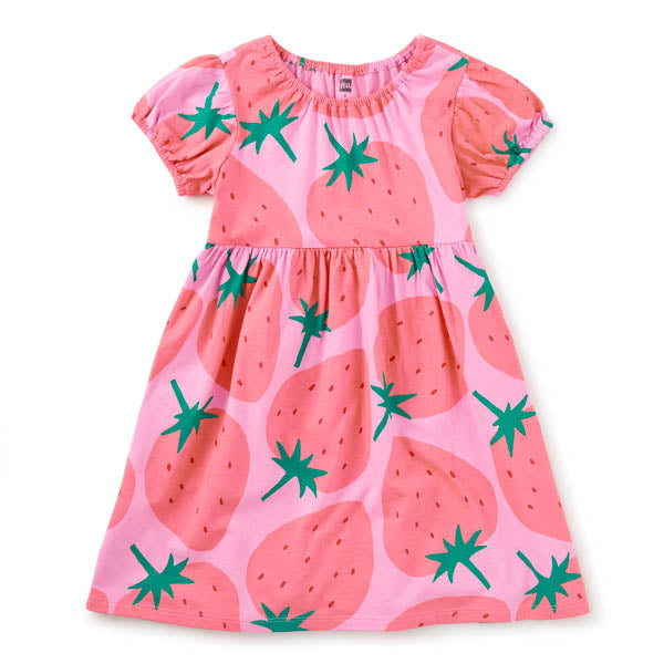 Pink dress with strawberry pattern on a white background