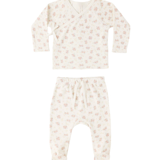 Baby outfit set with long-sleeve top and footed pants on a white background