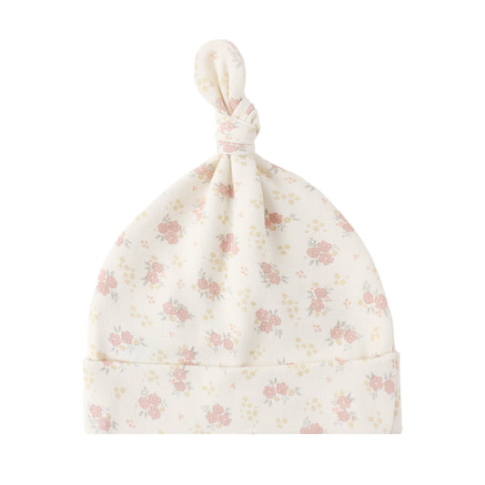 Floral patterned baby hat on a white background