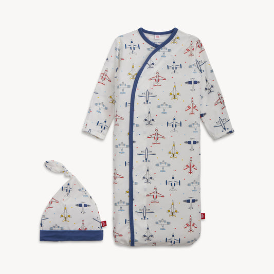 Baby onesie with airplane pattern and matching hat on a white background
