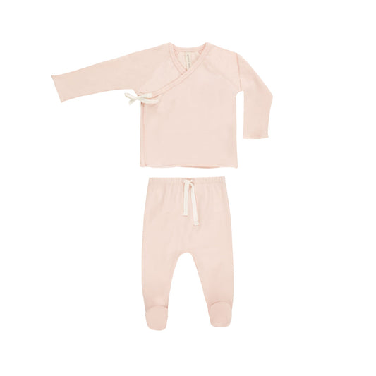 Pink baby outfit with top and pants on a white background