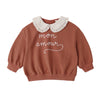 Brown sweatshirt with white collar and 'mon amour' text on a white background