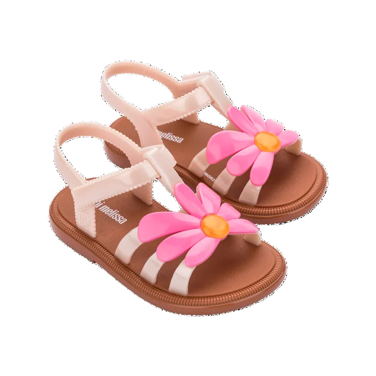 Children's sandals with pink floral decorations on a white background