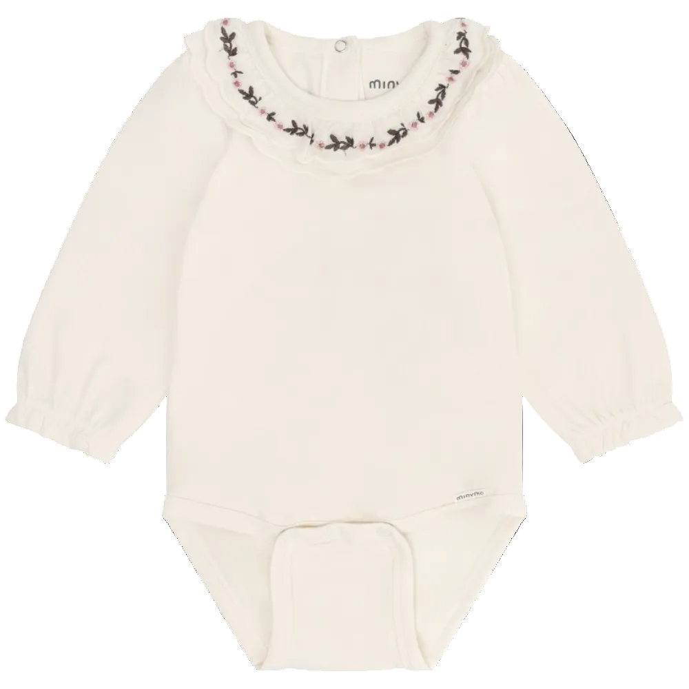 White baby bodysuit with floral embroidery on neckline against a white background