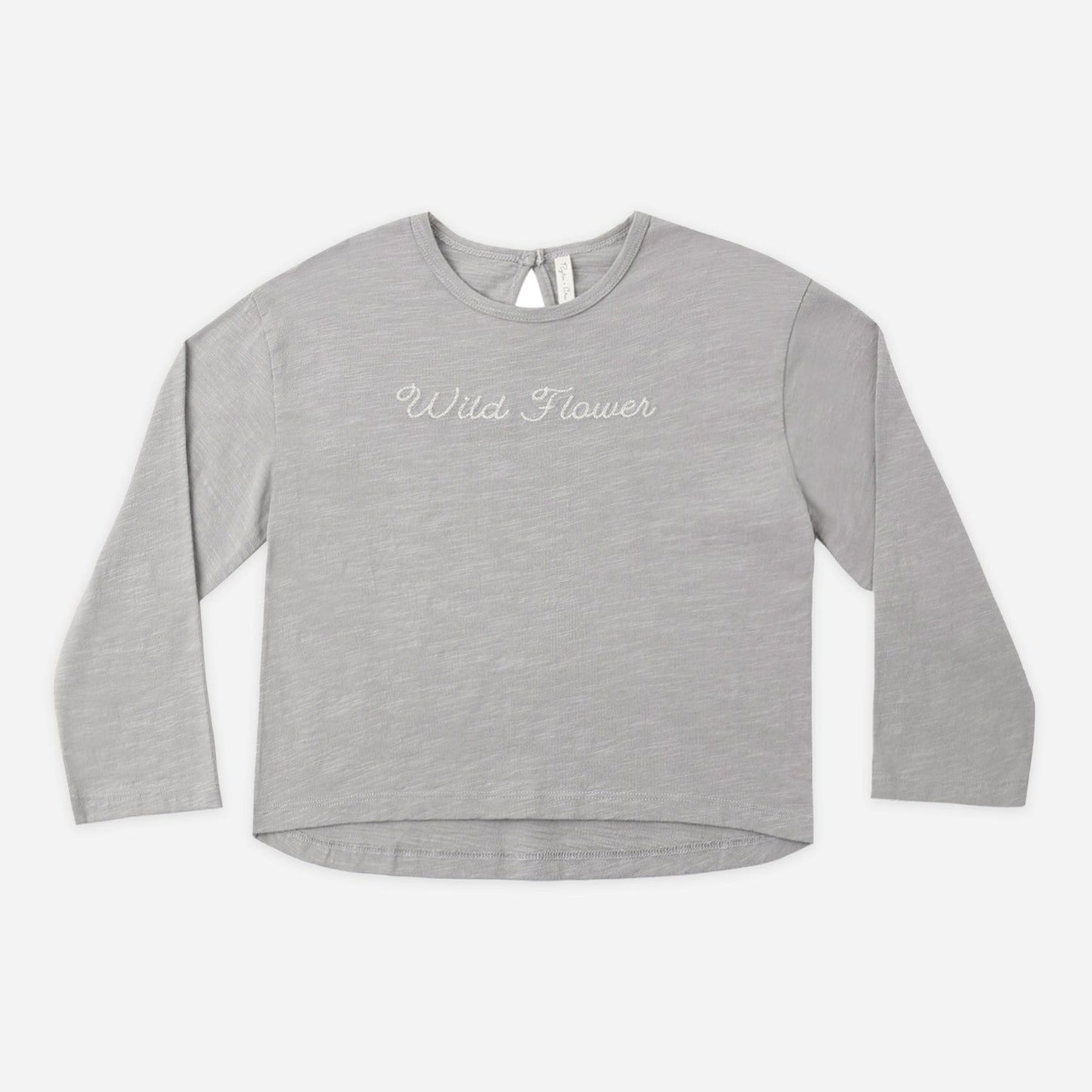 Girl wearing the Wildflower Luna long sleeve top on a dusty blue background