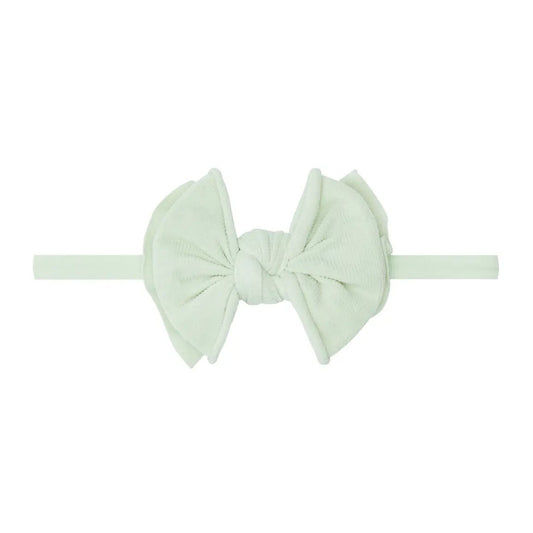 Light green headband with a bow on a white background